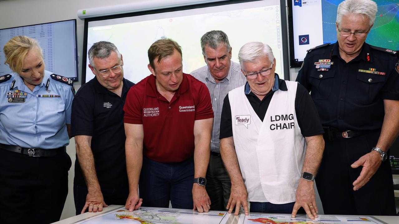 Queensland Police Commissioner Katarina Carroll, Senator Murray Watt, Deputy Premier Steven Miles, Queensland Local Government Minister Mark Furner, Cairns Mayor Terry James and Queensland Fire and Emergency Services Assistant Commissioner Brad Commens look over flood zone maps for the Cairns region at the Cairns Local Disaster Coordination Centre. Picture: Brendan Radke