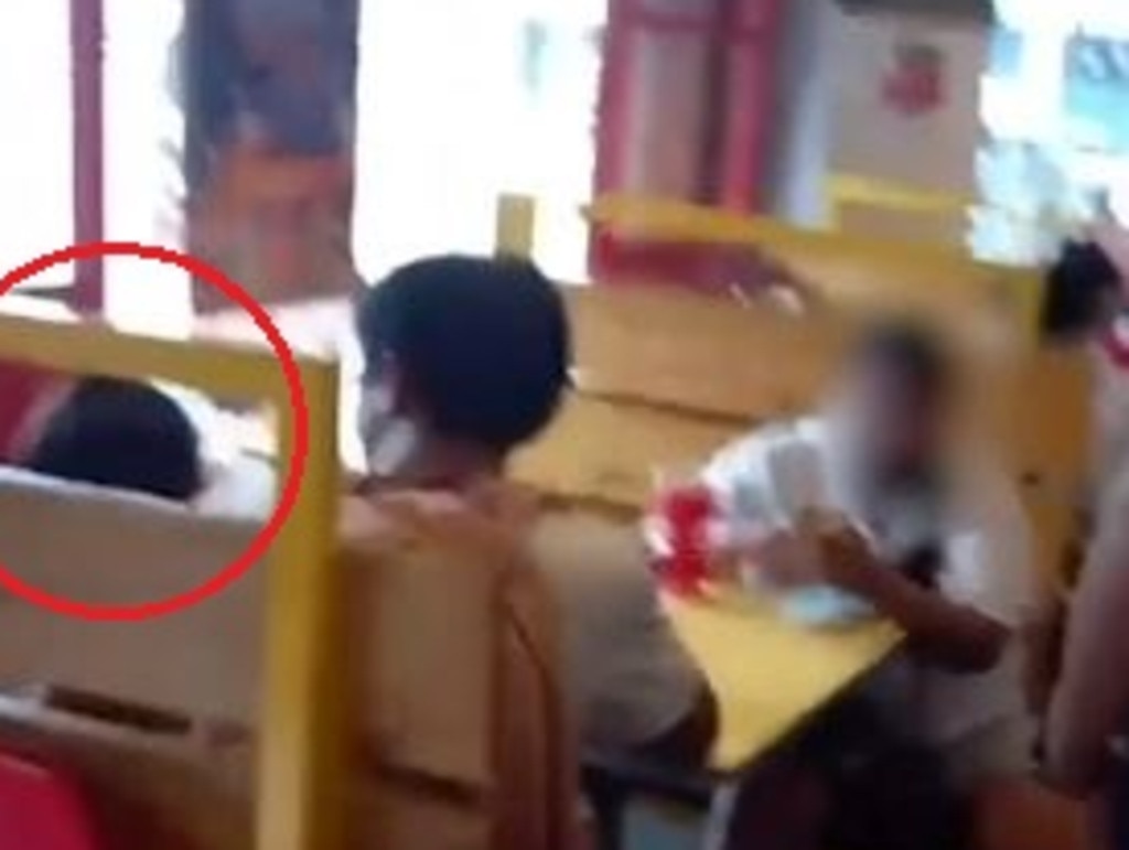 Police footage shows officers approaching the woman, who was with another adult, and the child in a fast food restaurant. Picture: AFP