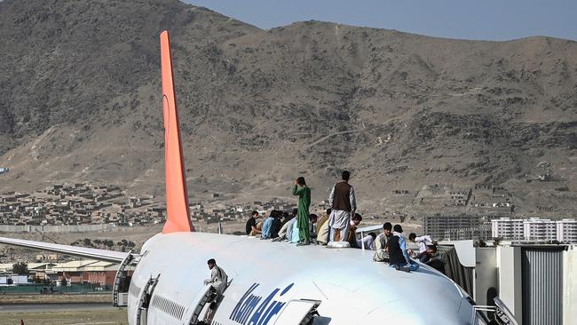 Shocking photos and video of people dying while trying to flee on departing planes have emerged from the crisis. (Photo by Wakil Kohsar / AFP)