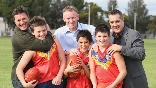 Maynard and his dad Peter Maynard (right) with South Australian under-12 teammates Harrison Viney and Billy Stretch and their fathers Jay Viney and Steven Stretch.