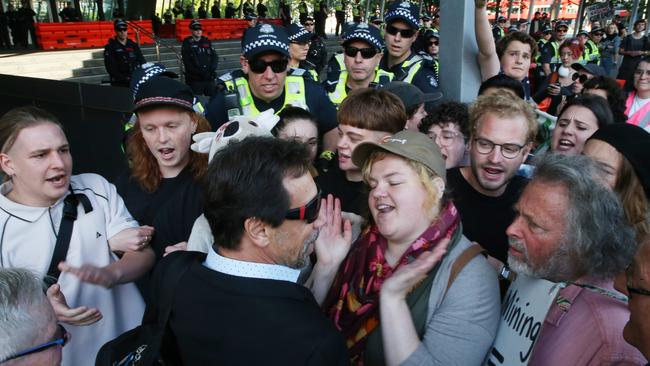 Protesters attempt to stop conference members entering the Melbourne Convention and Exhibition Centre. Picture: AAP