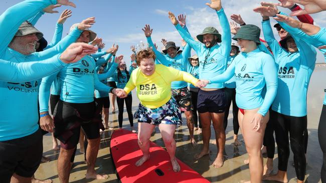 Ocean Grove Disabled Surfers Association is holding one of its two annual events where more than 100 volunteers hit the water to assist people with disabilities get a safe ride in the surf.Birthday and Surfer girl Kate Nolan with volnteersPicture: Mark Wilson