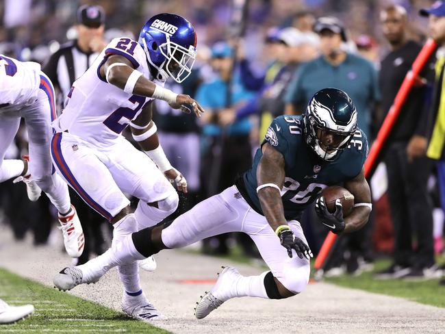 Corey Clement gets hit out of bounds by Landon Collins of the New York Giants. Picture: Getty Images