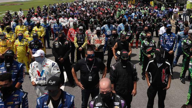 NASCAR team members stood in solidarity with Bubba Wallace at Talladega Superspeedway on June 22. A noose was found in the garage stall of Wallace a week after NASCAR banned the Confederate flag at its facilities. Picture: Chris Graythen/Getty Images/AFP