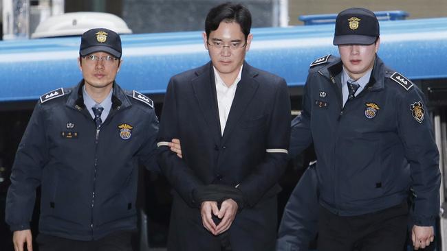 Lee Jae-yong is led into the office of the independent counsel in Seoul. Pic: AP