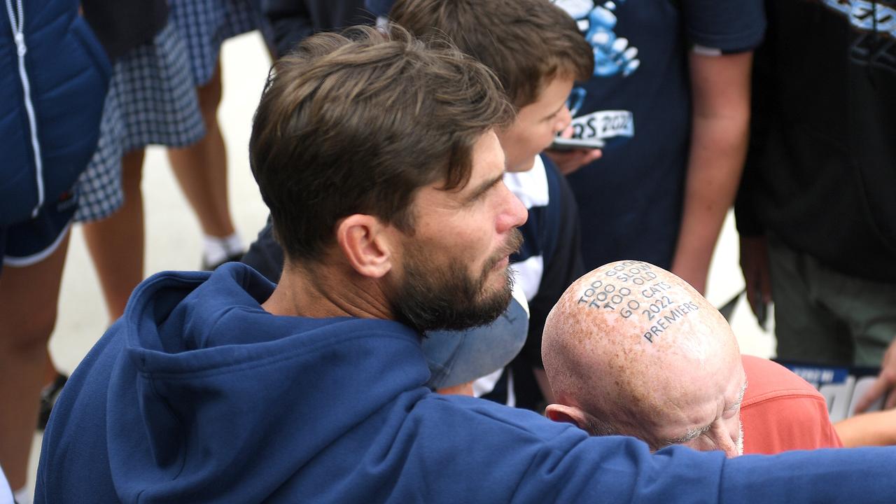 WARRNAMBOOL, AUSTRALIA - FEBRUARY 06: Tom Hawkins of the Cats speaks with a fan who had his head tattooed to commemorate the 2022 Cats premiership win during the Geelong Cats AFL Community Camp at Reid Oval on February 06, 2023 in Warrnambool, Australia. (Photo by Morgan Hancock/Getty Images)