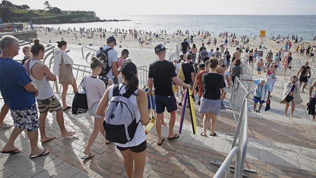 Hundreds of people head to the beach at Coogee in Sydney. Picture: Adam Yip