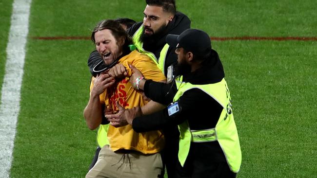 SYDNEY, AUSTRALIA - OCTOBER 02: A pitch invader is apprehended by security staff during the 2022 NRL Grand Final match between the Penrith Panthers and the Parramatta Eels at Accor Stadium on October 02, 2022 in Sydney, Australia. (Photo by Jason McCawley/Getty Images)
