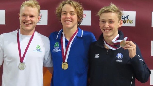 Albany Creek's Samuel Short, middle, after his medal haul at Chandler. On his left is his Albany Creek team mate Daniel Jacobson.