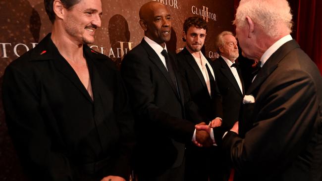 Britain's King Charles III meets US actor Denzel Washington upon arrival for the Royal film performance and World premiere of the film "Gladiator II" at the Odeon Lux, in Leicester Square, central London, on November 13, 2024. (Photo by Eddie MULHOLLAND / POOL / AFP)