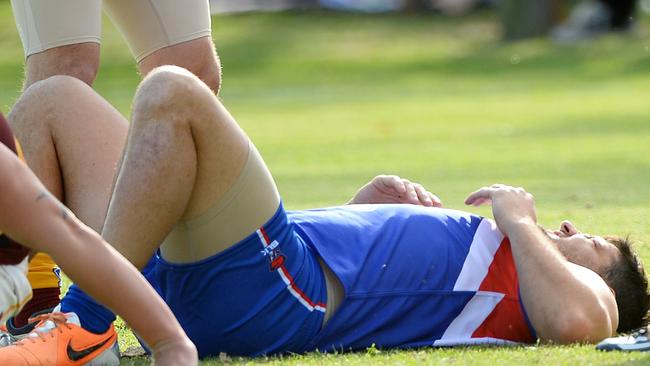 Brendan Fevola flat on his sore back after a marking contest.