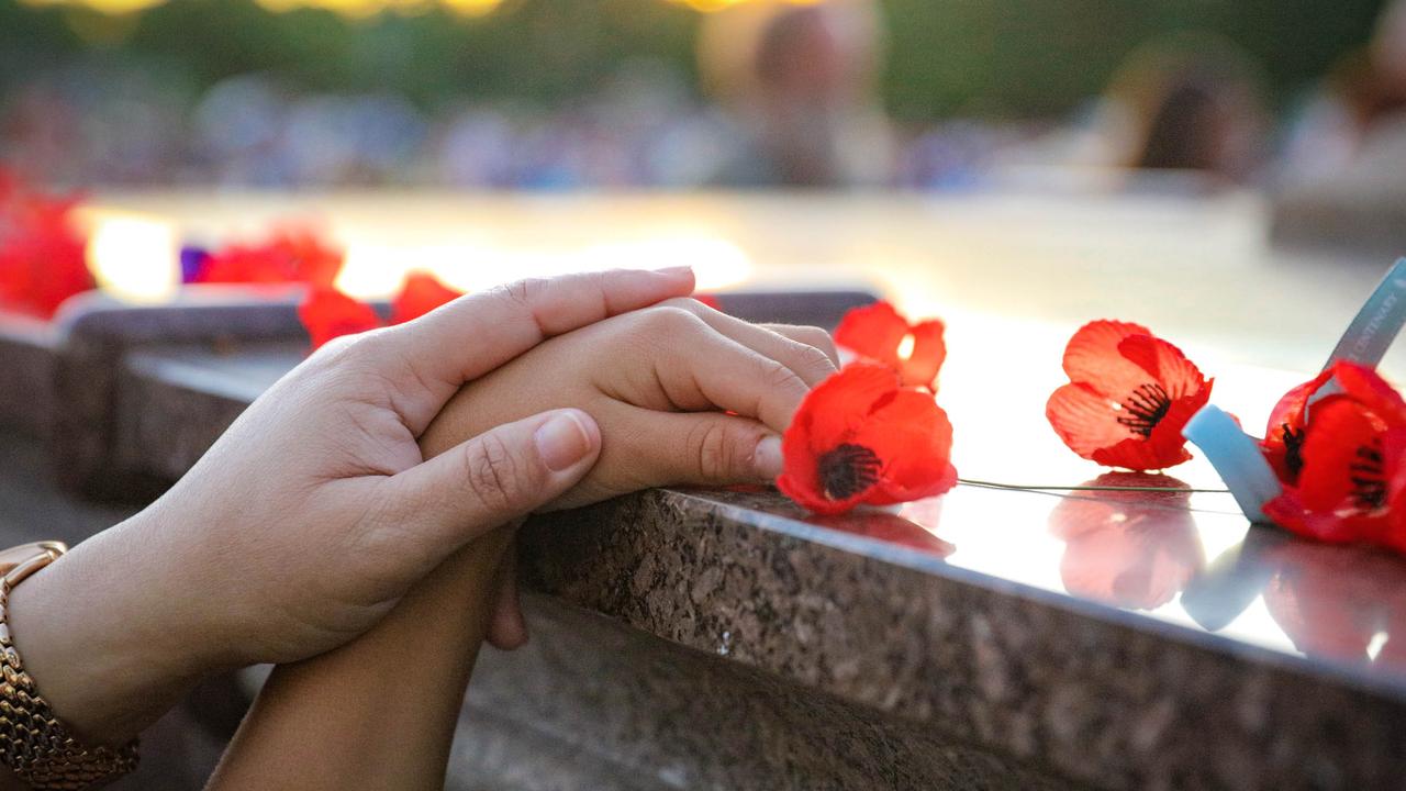 Poppys being laid at The Dawn Service at Darwins Cenotaph commemorating ANZAC Day 2021. Picture Glenn Campbell