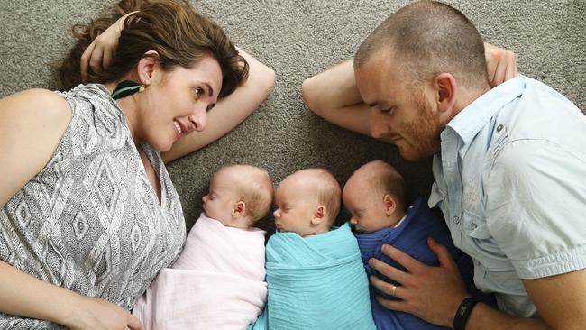 Lanai and James Scarr at home in Canberra with their six-week-old triplets Edith, Jim and Nate. Pictures: Justin Lloyd