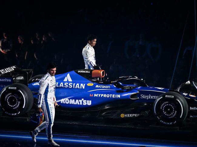 Williams' Spanish driver Carlos Sainz (front) and Williams' Thai driver Alexander Albon (rear) walk on stage past the new Formula 1 car of Williams Formula One Team presented during the Formula One - 2025 season launch âF1 75 LIVEâ event at the O2, in London, on February 18, 2025. Auto: (Photo by Ben STANSALL / AFP) / --- RESTRICTED TO EDITORIAL USE ---