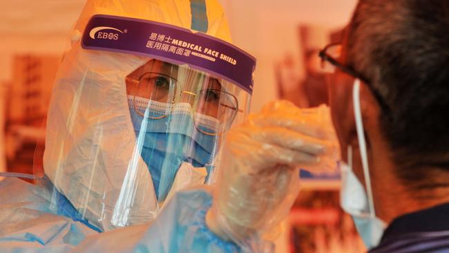 A medical worker conducts a Covid test in Qingdao, in China's eastern Shandong province. Picture: AFP