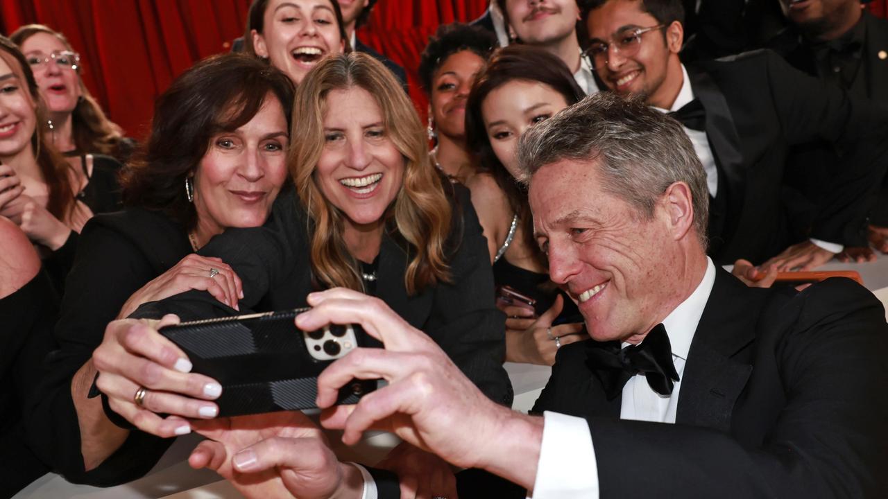 Hugh Grant appeared in better spirits when taking selfies with fans on the red carpet. Picture: Emma McIntyre/Getty Images