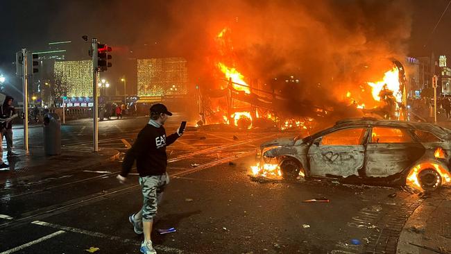 Flames rise from a car and a bus, set alight at the junction of Bachelors Walk and the O'Connell Bridge, in Dublin.