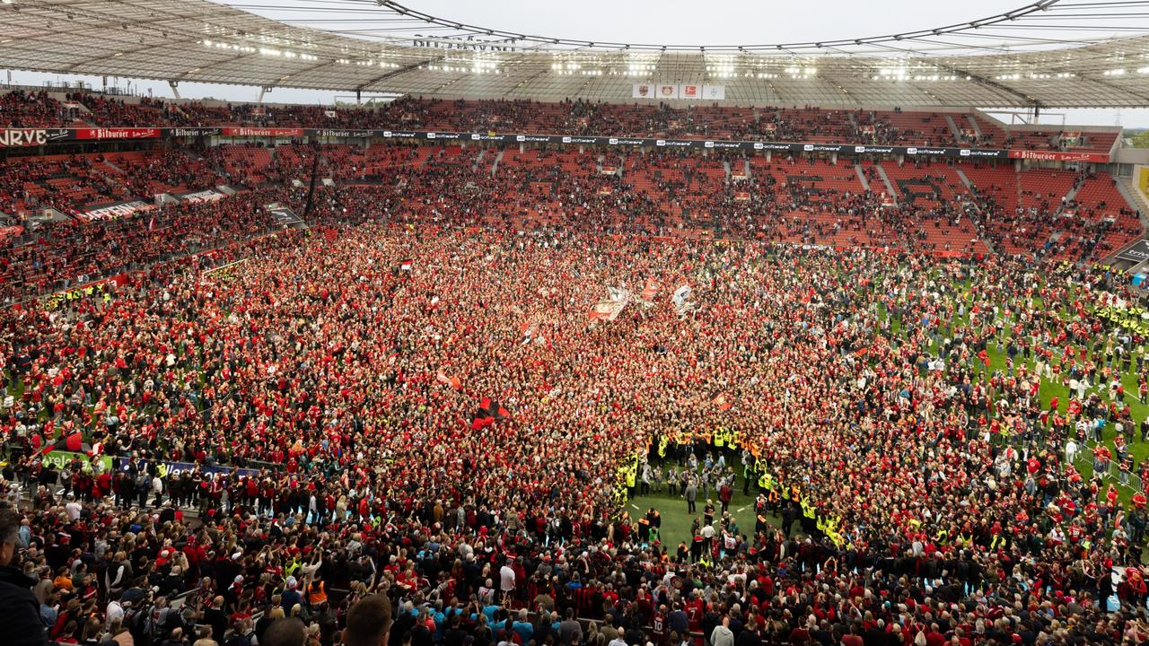 Leverkusen supporters celebrated with a pitch invasion. (Photo by Andreas Rentz/Getty Images)