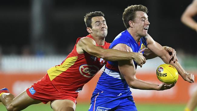 Bulldogs midfielder Jack Macrae is tackled by Gold Coast’s Lachie Weller. Picture: Getty Images