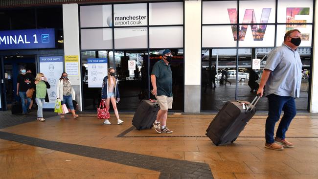 Passengers exit Terminal 1 after landing at Manchester Airport.