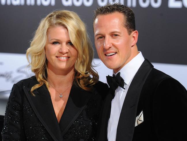 Formula-One driver Michael Schumacher and his wife Corinna arrive for the GQ gala 'Men of the Year' in Berlin on October 29, 2010.  AFP PHOTO / JENS KALAENE  GERMANY OUT / AFP PHOTO / DPA / JENS KALAENE