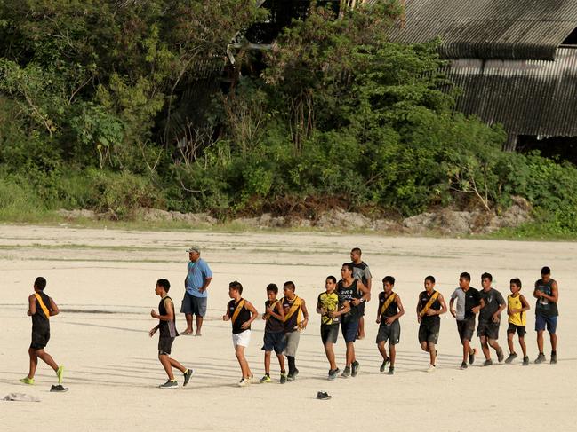 Daily Telegraph. Nauru Day 4.  Nauru Island life. Local Nauruan Kids practice their AFL on a dirt oval.    Pic Nathan Edwards