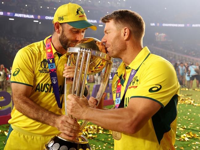 AHMEDABAD, INDIA - NOVEMBER 19: Glenn Maxwell and David Warner of Australia poses with the ICC Men's Cricket World Cup Trophy following the ICC Men's Cricket World Cup India 2023 Final between India and Australia at Narendra Modi Stadium on November 19, 2023 in Ahmedabad, India. (Photo by Robert Cianflone/Getty Images)