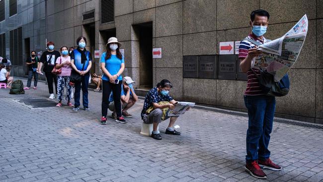 Residents line up for free COVID-19 test kits in the Sham Shui Po district of Hong Kong on Wednesday. Picture: AFP