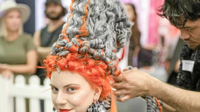 Pirekopa Taylor designs his avant garde winning piece at the Brisbane Hair Expo on model Rebecca Madigan.