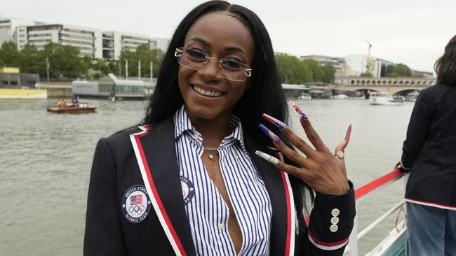 PARIS, FRANCE - JULY 26: Sha'Carri Richardson poses for a photo while riding with teammates on a boat with teammates along the Seine River during the Opening Ceremony of the Olympic Games Paris 2024 on July 26, 2024 in Paris, France. (Photo by Ashley Landis - Pool/Getty Images)