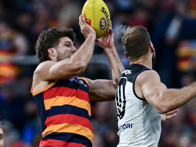 ADELAIDE, AUSTRALIA - MAY 03: Jordon Butts of the Crows marks behind c10during the round eight AFL match between Adelaide Crows and Carlton Blues at Adelaide Oval, on May 03, 2025, in Adelaide, Australia. (Photo by Mark Brake/Getty Images)