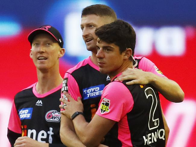 The Sixers’ Jackson Bird (centre) and Moises Henriques celebrate after combining to dismiss Renegades batsman Shaun Marsh on Thursday night. Picture: Getty Images