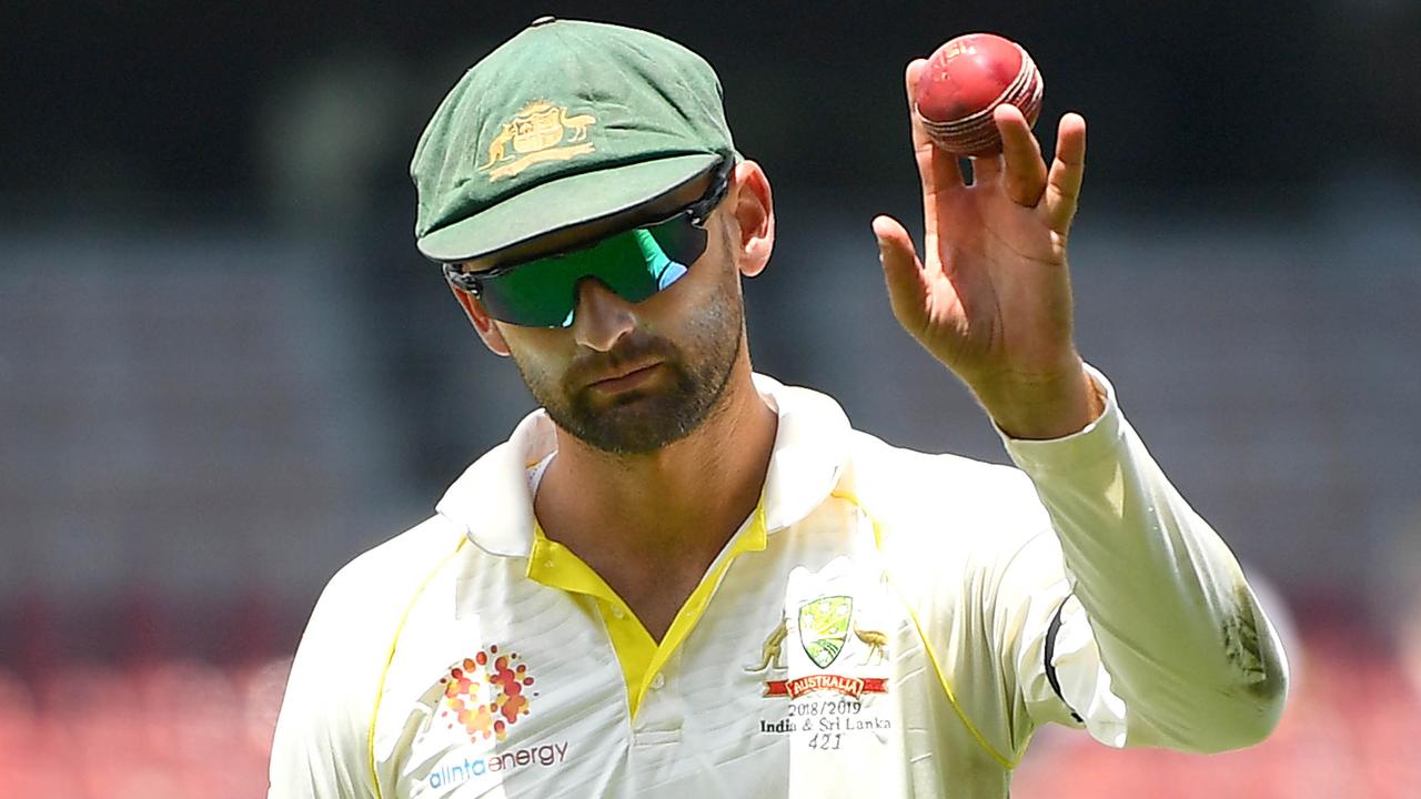 Nathan Lyon of Australia holds the ball up to the crowd after taking 6 wickets during day four.