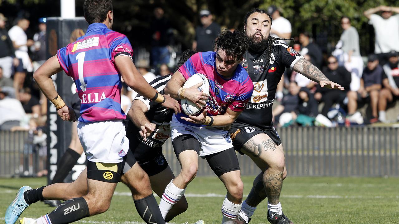 Alexandria Rovers' Adam Morgan is tackled. Picture: John Appleyard