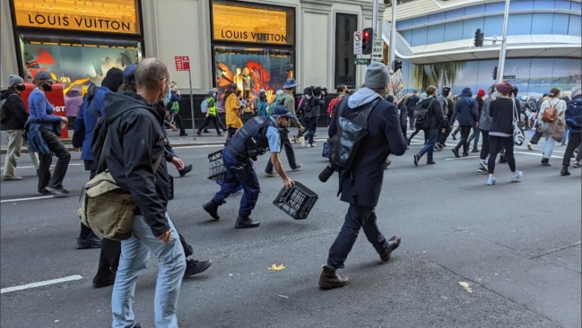 Demonstrators could be seen throwing milk crates in the middle of the road to block cars, with NSW Police officers forced to remove them as they chase them down. Picture: Blockade Australia