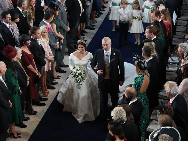 Britain's Princess Eugenie of York accompanied by Britain's Prince Andrew, Duke of York walks up the aisle during her wedding ceremony to Jack Brooksbank. Picture: AFP