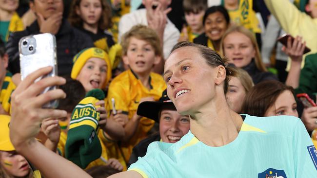 BRISBANE, AUSTRALIA - AUGUST 19: Emily Van-Egmond of Australia takes a selfie with fans after the FIFA Women's World Cup Australia & New Zealand 2023 Third Place Match match between Sweden and Australia at Brisbane Stadium on August 19, 2023 in Brisbane, Australia. (Photo by Cameron Spencer/Getty Images)