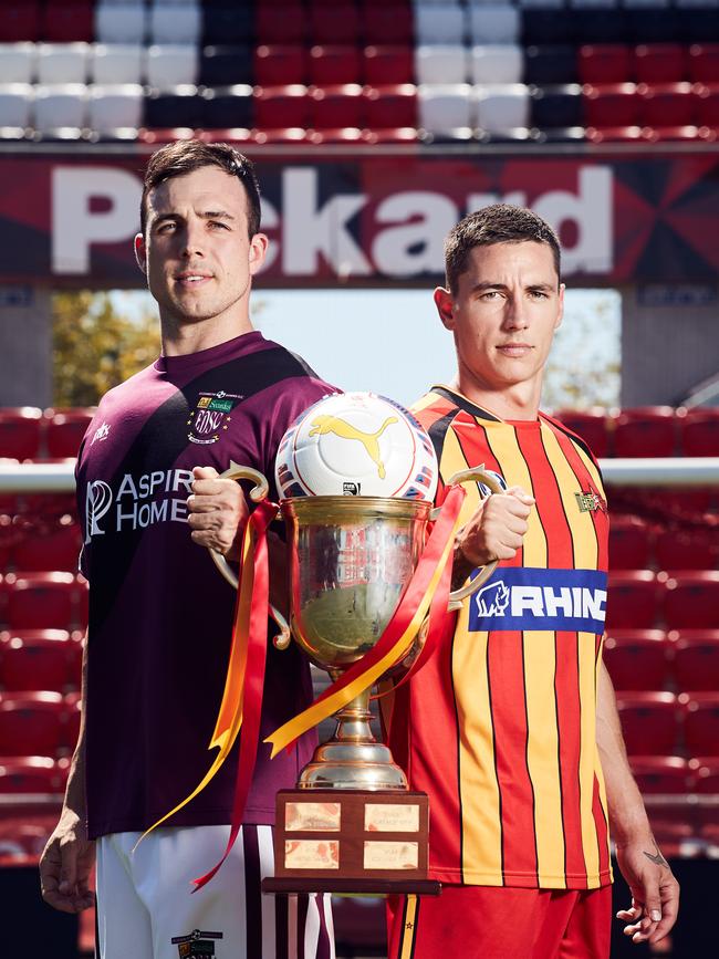 Matt Watson from Elizabeth Downs and former MetroStars player Liam Wooding with the FFA Cup SA last year. Picture: AAP/Matt Loxton.