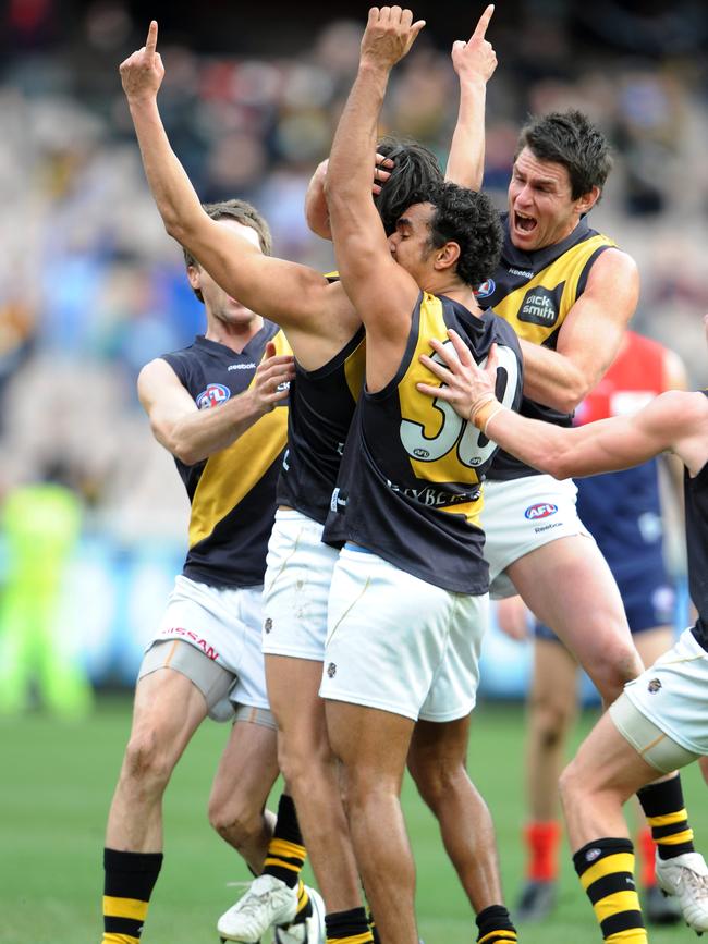 Jordan McMahon celebrates with Chris Newman and Richard Tambling after kicking the matchwinner against Melbourne.