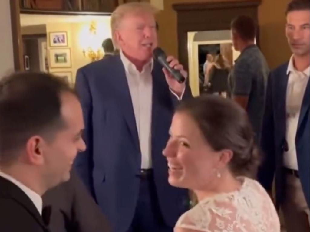 The beaming, ‘totally beautiul’ bride and her groom welcomed Donald Trump crashing their wedding. Picture: Supplied