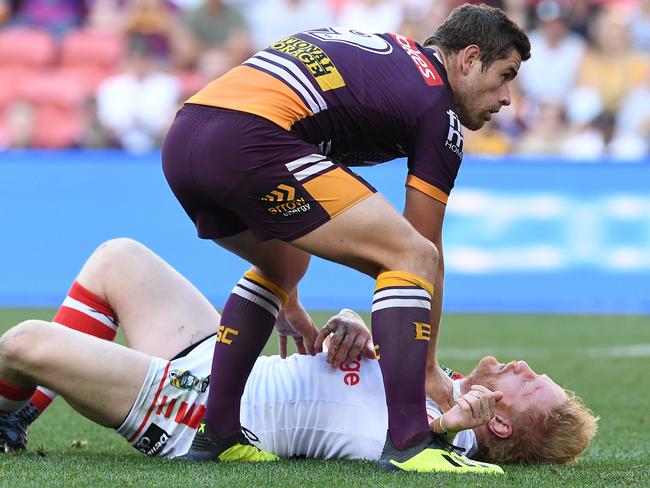 Andrew McCullough of the Broncos assists James Graham after he was knocked out. Picture: AAP Image/Dave Hunt