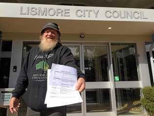 Bundjalung elder Michael Ryan delivering a NSW Land and Environment Court Summons on the Lismore City Council. Picture: Leah White