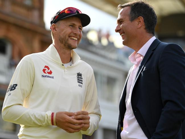 Michael Vaughan (R) shares a laugh with England captain Joe Root.