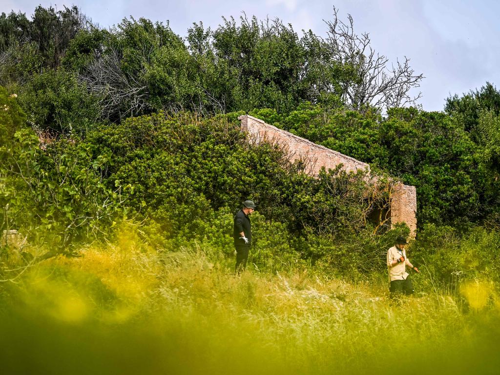 Criminal Investigators stand in a field near ruins during new search operations amid the investigation into the disappearance of Madeleine McCann at Atalaia, Lagos in the Algarve region. Picture: AFP