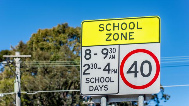 School zone road sign with speed limit 40 during before and after school hours.