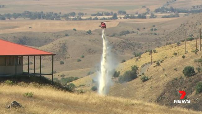 Water bombers helped firefighters bring a grass fire under control at Palmer. 7NEWS