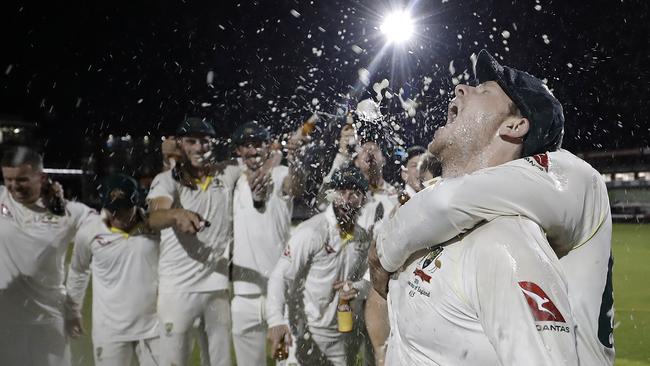 Steve Smith celebrates with team mates while singing the team song on the pitch. Picture: Getty