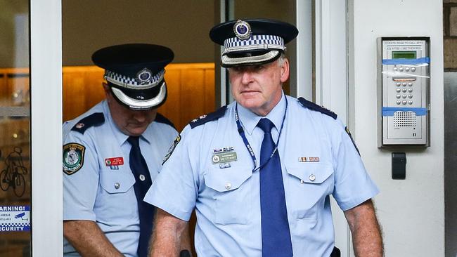 Two police sergeants leave Don Harwin’s Sydney home after he was fined for breaking lockdown laws. Picture: Matrix