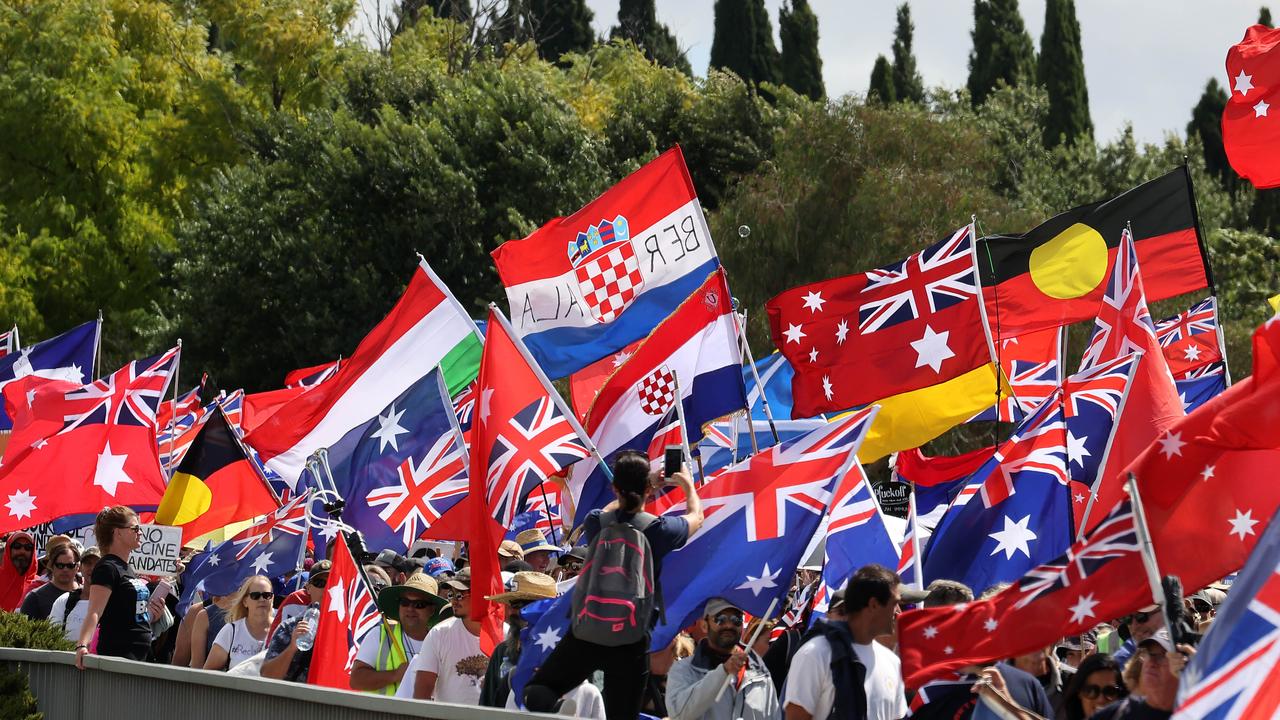 Protesters carried Australia Red Ensign and Aboriginal flags. Picture: NCA/Gary Ramage