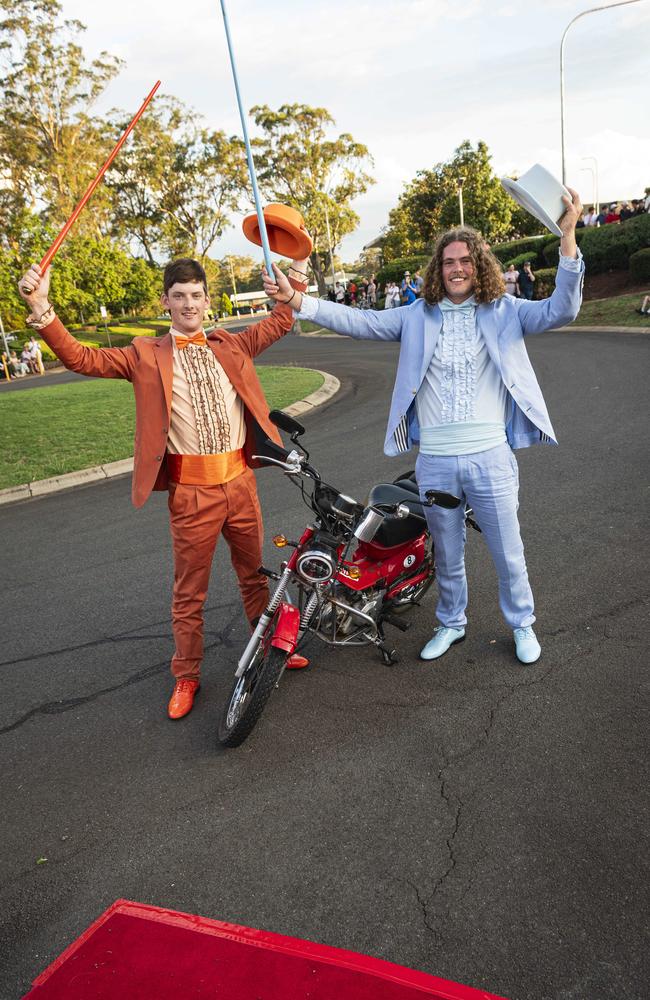 Graduate Daniel Sheath (right) and partner Matthew Thom arrive as Dumb and Dumber characters on a postie bike at Mary MacKillop Catholic College formal at Highfields Cultural Centre, Thursday, November 14, 2024. Picture: Kevin Farmer